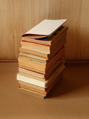 Pile of Old Books on Brown Background