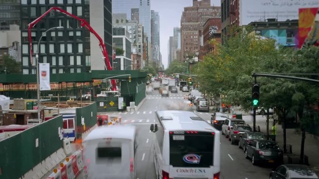NEW YORK CITY - Circa October, 2018 - A day time lapse view of traffic on 10th Avenue in midtown Manhattan on an early Autumn overcast day.  	