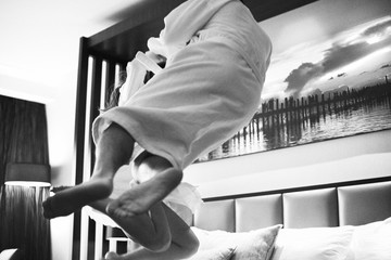 Love lives forever Senior couple at home. Handsome old man and attractive old woman are enjoying spending time together. Having fun and jumping in bed.