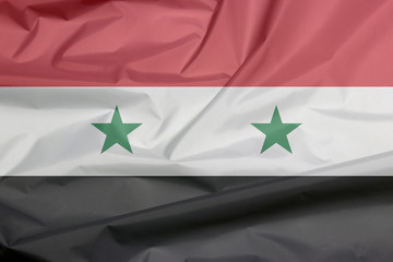 Fabric flag of Syrian Arab Republic. Crease of Syrian flag background, A horizontal tricolor of red white and black with two green stars at the centre.