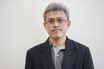 Middle aged man with gray hair on white background