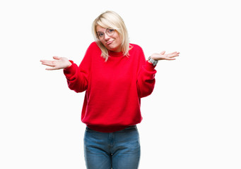 Young beautiful blonde woman wearing sweater and glasses over isolated background clueless and...