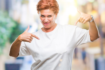 Atrractive senior caucasian redhead woman over isolated background looking confident with smile on...