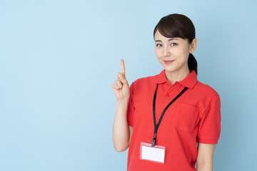 portrait of young asian woman wearing red polo shirts on blue background