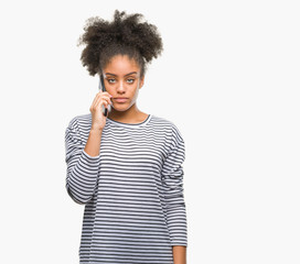 Fototapeta na wymiar Young afro american woman talking on the phone over isolated background with a confident expression on smart face thinking serious