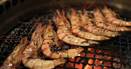 Grill shrimp in metal net at restaurant