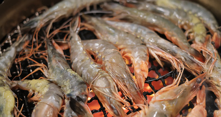 Grill shrimp in metal net at Japanese restaurant