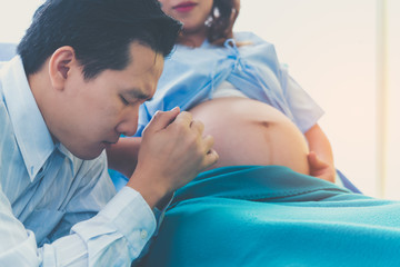 The man is a husband worried about his wife's pregnancy, childbirth greatly.