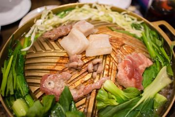 Thai barbecue buffet. Sliced pork on hot pan.