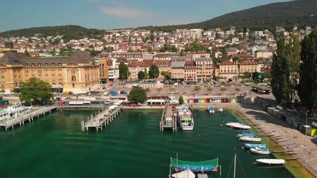 Drone dollyshot sideways view of the city of Neuchatel, Switzerland and its lakeshore