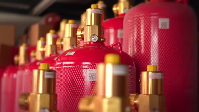 Red gas cylinders with pressure valves.