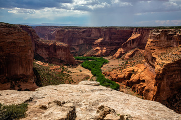 Canyon de Chelly from Spider Rock Point looking west at gathering monsoon storms. Canyon de Chelly National Monument in northeast Arizona.