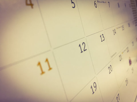 White calendar is adjusted with brown tone, the month are sort by date as the square table which was empty space. Picture in blurred background, for wallpaper or backdrop