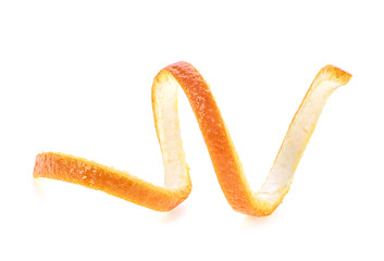 Single orange peel on a white background. Orange zest spiral.