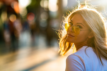 Blond girl on white T shirt walking Hollywood Blvd on sunset