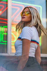 Obraz na płótnie Canvas Blond girl on white T shirt walking Hollywood Blvd on sunset