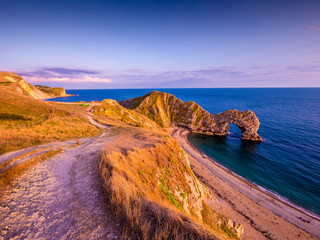 Sunset over Durdle Door - the most famous landmark in Devon England