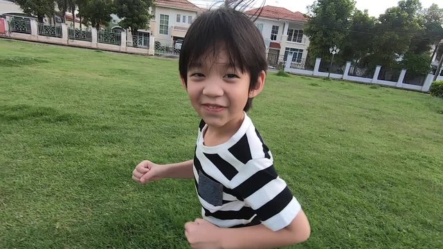 Asian child playing in the park slow motion 