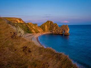 Sunset over Durdle Door - the most famous landmark in Devon England