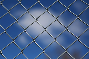 Fototapeta premium Blue Sky Behind the Wire Fence