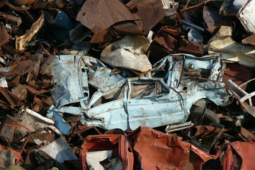 Crumpled crashed car among the same at the dump