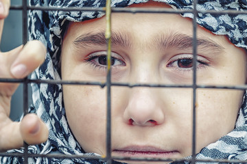 a refugee girl from the east in a headscarf