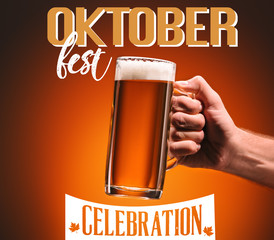 cropped shot of man holding mug of cold beer on orange background with "oktoberfest celebration" lettering