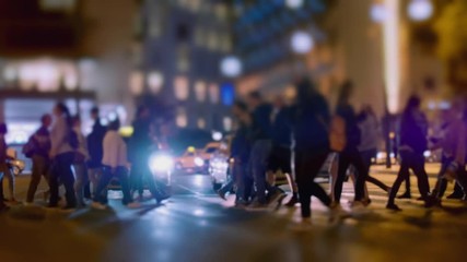 4K City pedestrians at night,crossing big city intersection.No logos or faces,commescial shot.