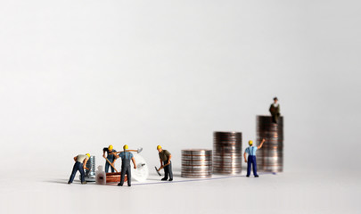 A concept of inequality in income distribution. The pile of coins and miniature people.