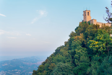 Fototapeta na wymiar Castle of San Marino on the hill. Republic of San Marino is an enclaved microstate surrounded by Italy, situated on the Italian Peninsula on the northeastern side of the Apennine Mountains