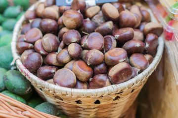 close up of ripe chestnuts in a basket at the farmer's market