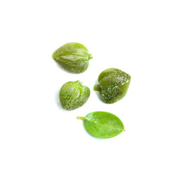Capers on white, top view. Caper with green leaves on white background