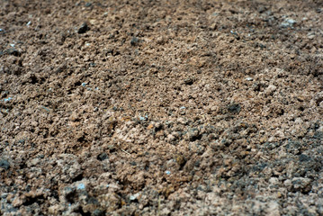 Abstract background and texture of .lateritic soil with the shadow of steel structure on the ground at construction site