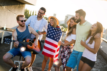 Friends Celebrating 4th Of July Holiday on rooftop