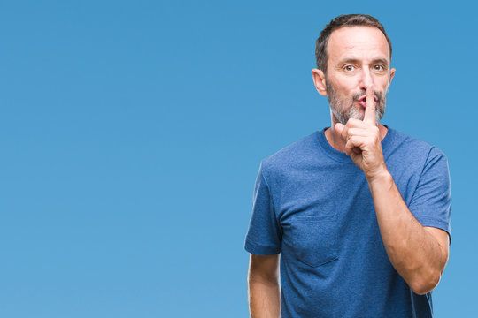 Middle age hoary senior man over isolated background asking to be quiet with finger on lips. Silence and secret concept.