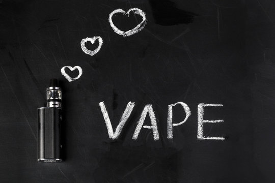 electronic cigarette on a chalkboard with painted hearts near and inscription vape, background image with space for text