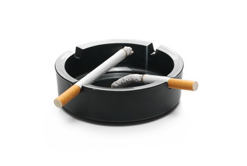 Lit cigarette in black ashtray isolated on white background