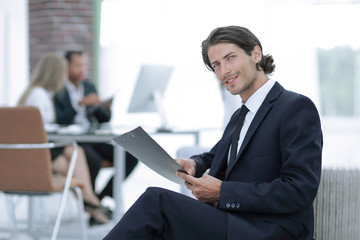 confident businessman studying the document in his office