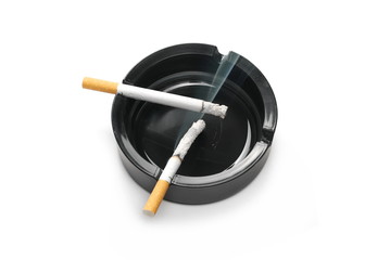 Lit cigarette in black ashtray isolated on white background