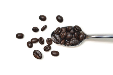 Coffee bean in a spoon on white background - isolated