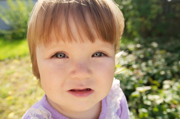 Cute baby girl portrait at summer. Adorable child outdoor in park