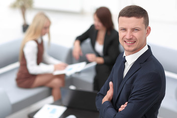 young businessman on blurred background office.