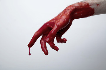 Bloody hand against a light background. halloween horror concept - obrazy, fototapety, plakaty