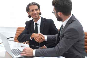 handshake business partners after discussing