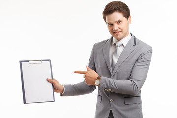 Young businessman showing blank clipboard, isolated on white background. Success in business, job and education concept shot
