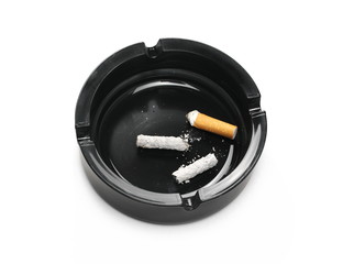 Lit cigarette in black ashtray isolated on white background