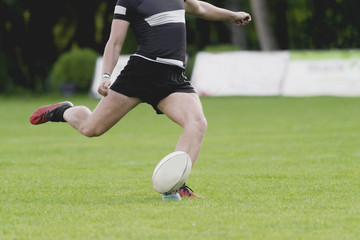 Rugby player kicking off. Team sport