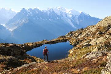 Hiker looking at Lac des Cheserys on the famour Tour du Mont Blanc near Chamonix, France.