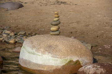 Fototapeta na wymiar Stones Balance on a Background of Sea. Calm and Meditation. Concept of Harmony and Balance.