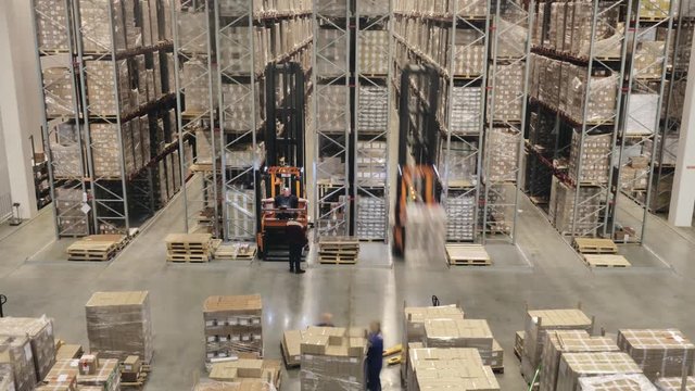 Loaders and forklift transport containers on big modern warehouse, time lapse.